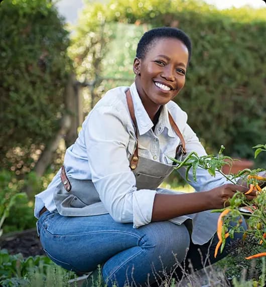 Smiling farmer woman in garden